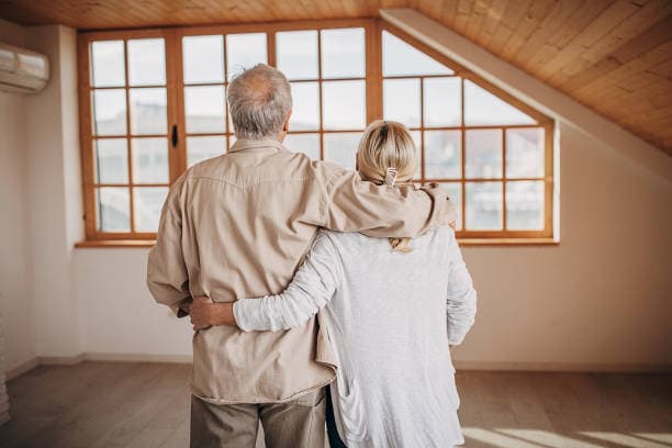 Couple standing together in an empty home