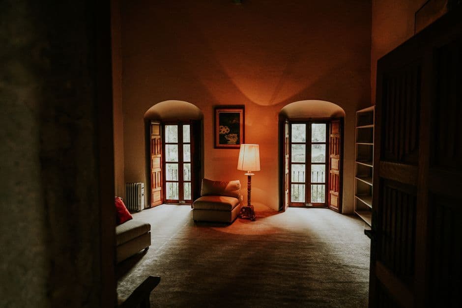 A warm and inviting rustic living room with vintage decor and cozy lighting.