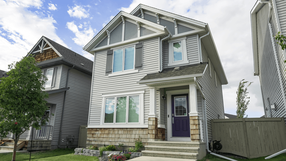 Contemporary suburban home with a front porch and clear blue sky, ideal for real estate themes.