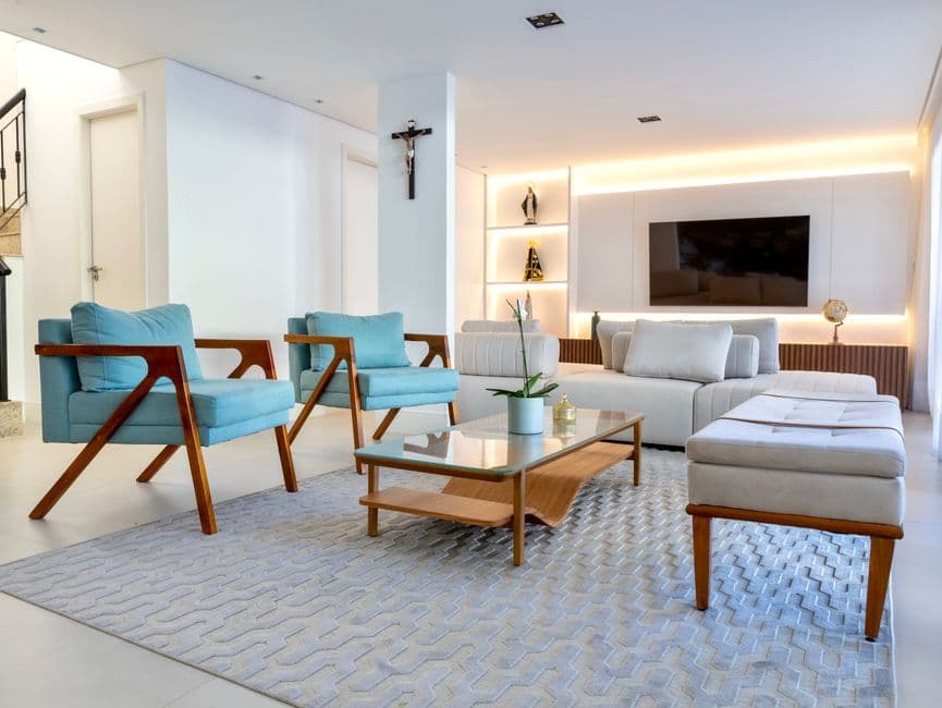Modern living room featuring blue armchairs and a sleek decor style.
